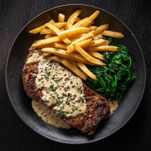 Ribeye Steak with Peppercorn Cream Sauce, Sautéed Spinach & Fries
