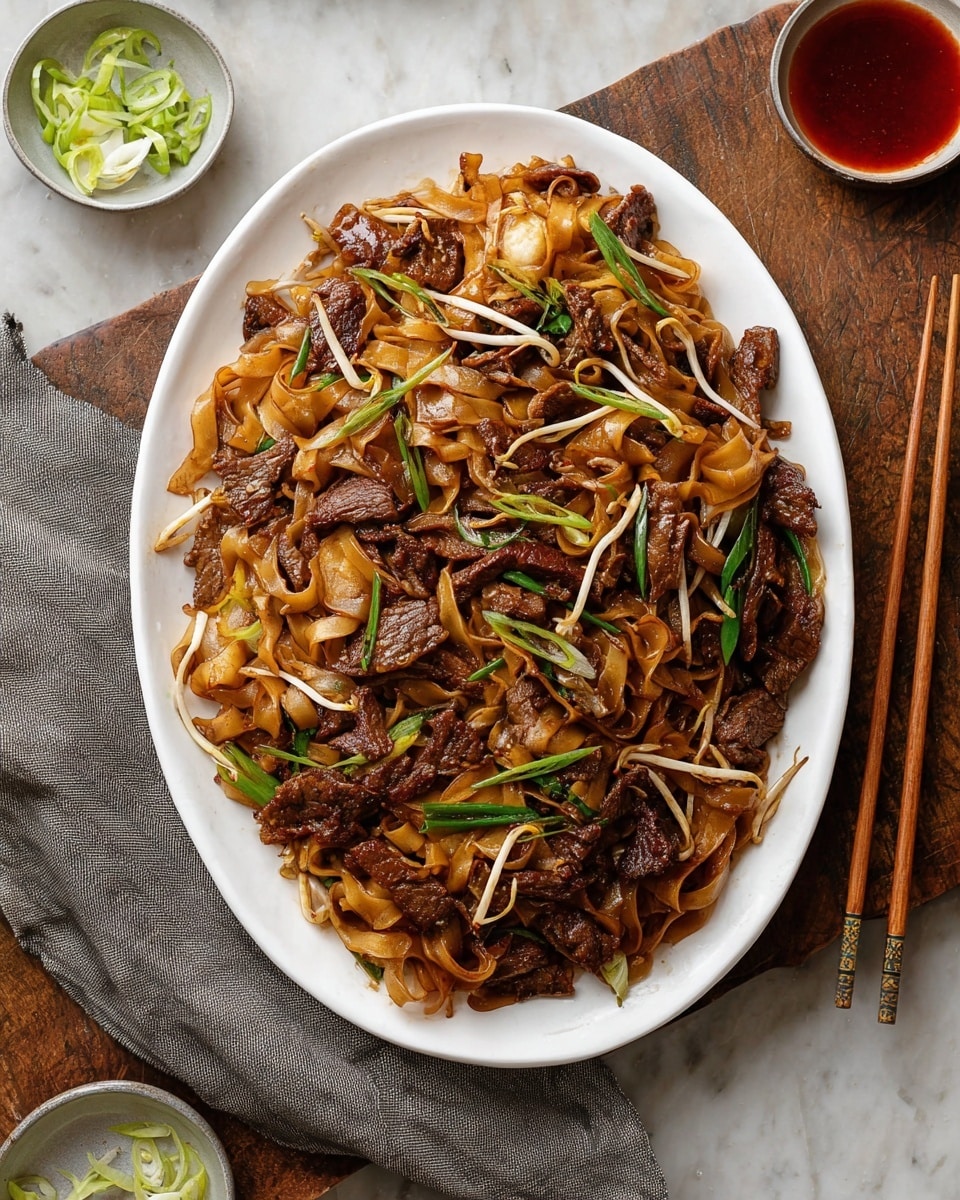 The image shows a white bowl filled with wide, flat noodles that are dark brown and glossy from sauce, mixed with leafy green vegetables and bean sprouts. There are several pieces of dark brown cooked meat scattered throughout the noodles. Thin rings of light green spring onions are sprinkled on top. A pair of wooden chopsticks rests on the right side of the bowl. The bowl is placed on a dark wooden table with small bowls of chopped spring onions, red sauce, and bean sprouts nearby. The overall texture looks moist and savory. Photo taken with an iphone --ar 4:5 --v 7