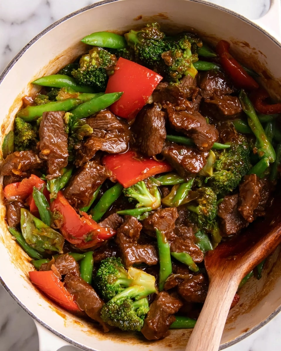 A close-up image of a white bowl filled with a colorful beef stir-fry. The dish has three main layers: tender brown beef pieces coated in sauce, bright green broccoli florets and snow pea pods, and slices of red bell pepper and orange carrot pieces, along with white chunks of onion. The beef looks juicy and glossy with a slightly textured surface, while the vegetables appear fresh and slightly shiny. The bowl sits on a white marbled surface with a pair of wooden chopsticks placed diagonally next to it. photo taken with an iphone --ar 4:5 --v 7