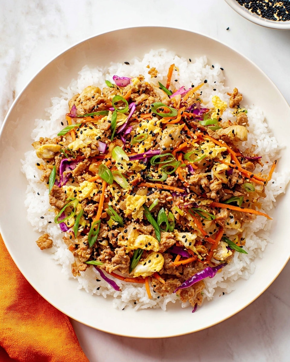 A white round plate holds a bed of fluffy white rice as the bottom layer. On top of the rice is a mixed stir-fry layer with small pieces of cooked light brown meat, thin strips of orange carrots, and thin slices of purple cabbage. There are also bits of cooked egg, finely chopped green onions scattered on top, and a sprinkle of black sesame seeds. The textures vary from soft rice to slightly crunchy vegetables. The plate sits on a white marbled surface with a hint of an orange cloth at the bottom left corner. Photo taken with an iphone --ar 4:5 --v 7