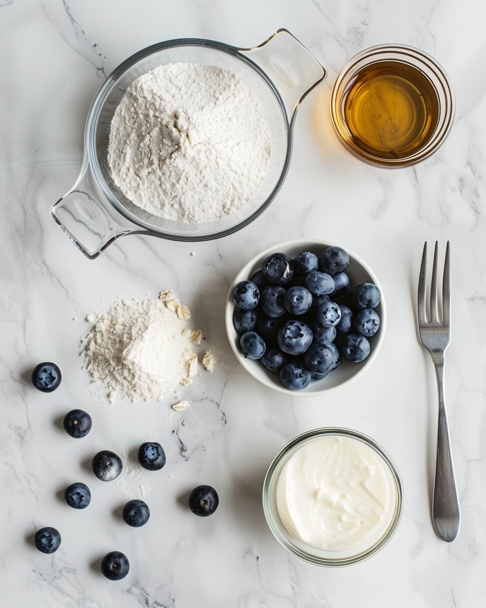Single white ceramic mug on a white marble surface filled with a freshly baked blueberry mug cake, showing a close-up angled view of a spoon lifting a portion to reveal the moist interior studded with plump blueberries and soft crumb texture, luscious blueberry juice seeping through the golden sponge, natural light highlighting the warm and inviting colors, styled as an intimate single serving from a food blog, photo taken with an iphone --ar 4:5 --v 7