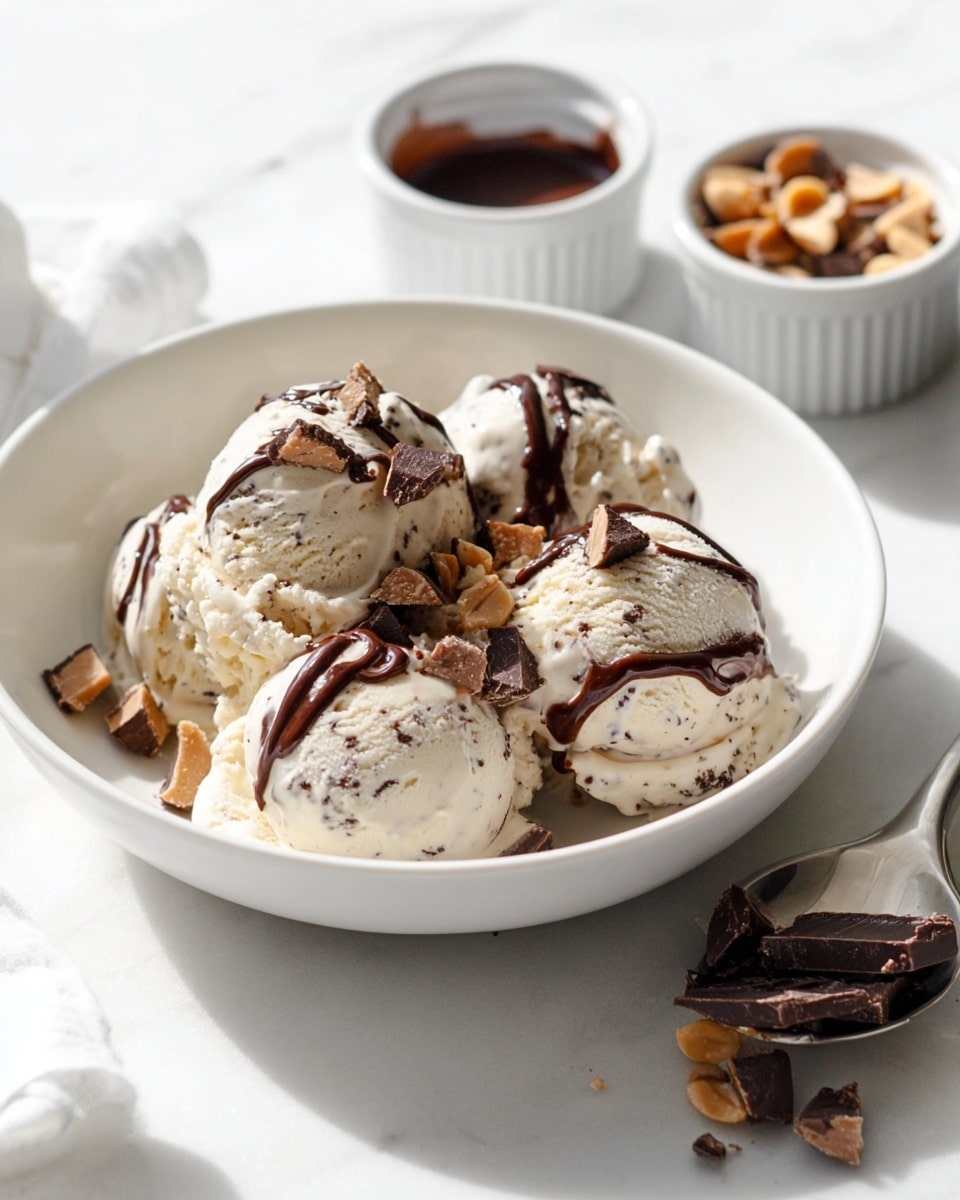 Large white bowl filled with multiple scoops of creamy vanilla ice cream speckled with chocolate bits, drizzled with rich chocolate sauce and topped with small pieces of peanut butter cups, accompanied by two small white ramekins—one filled with extra chocolate sauce and the other with chopped peanut butter cups, all arranged on a white marble countertop, natural lighting highlighting the textures, professional food styling photo taken with an iphone --ar 4:5 --v 7