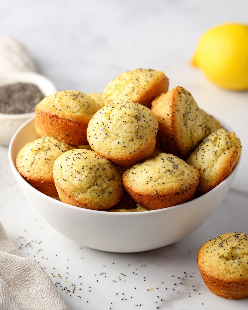 Large white bowl filled with a generous serving of many perfectly baked lemon poppy seed muffins, each golden brown with a light, fluffy texture speckled with tiny black poppy seeds, set against a clean white marble countertop with scattered poppy seeds and a whole fresh lemon in the background, natural lighting highlighting the muffins’ soft crumb and delicate crust, professional food styling, whole dish photographed at a 3/4 angle photo taken with an iphone --ar 4:5 --v 7