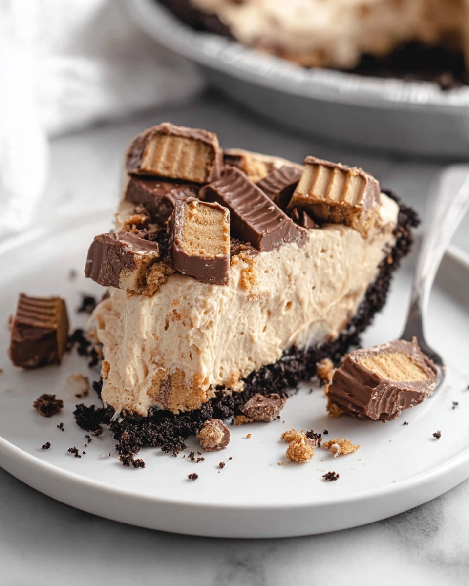 Whole creamy peanut butter pie with a dark chocolate cookie crust, topped generously with whole and halved peanut butter cups, presented in a white pie plate. The pie is arranged beautifully with smooth, light peanut butter filling and a crumbly chocolate crust that frames the dessert perfectly. The scene is captured with natural lighting on a white marble background, showing the entire, uncut pie from a professional 3/4 angle food magazine-style shot. Photo taken with an iphone --ar 4:5 --v 7